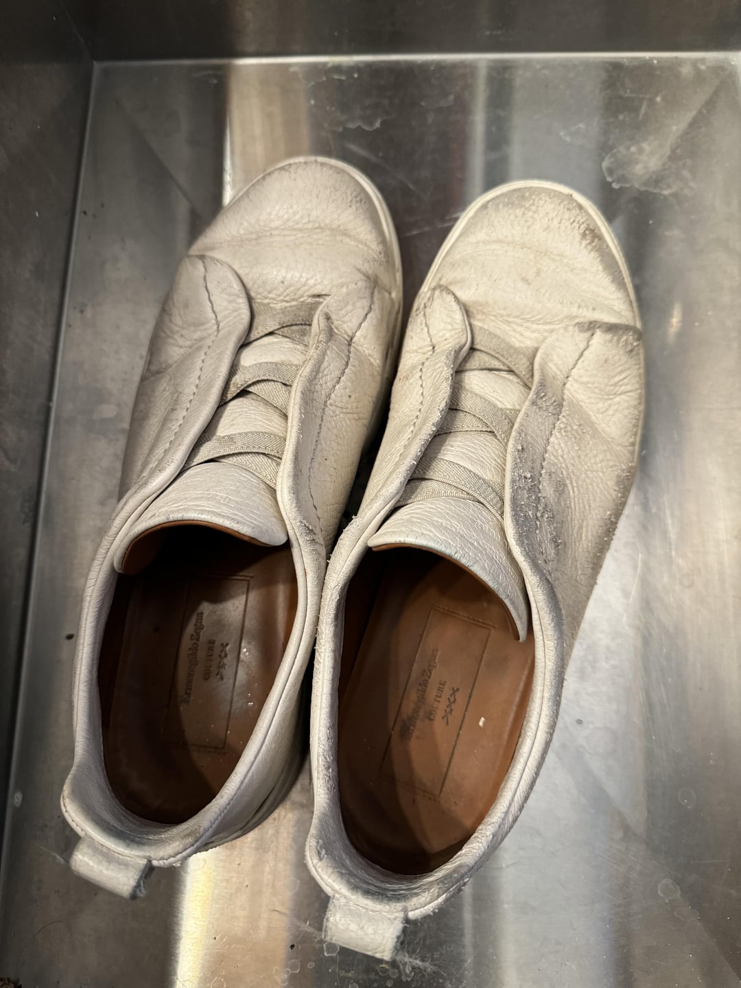 Illustrative example of white leather shoes